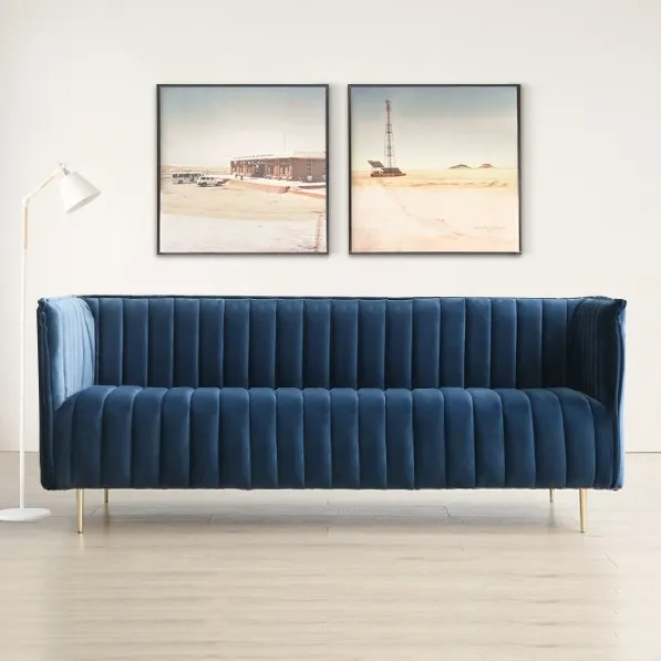 blue couch in a room with a lamp and pictures on the wall blue couch in a room with a lamp and pictures on the wall